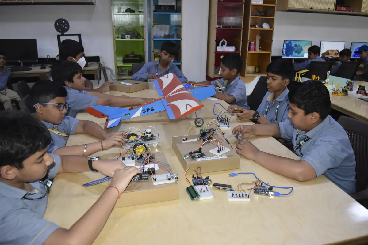 Students collaborating on robotics and electronics projects