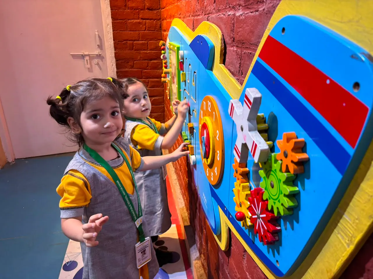 A young learner exploring a tactile activity wall