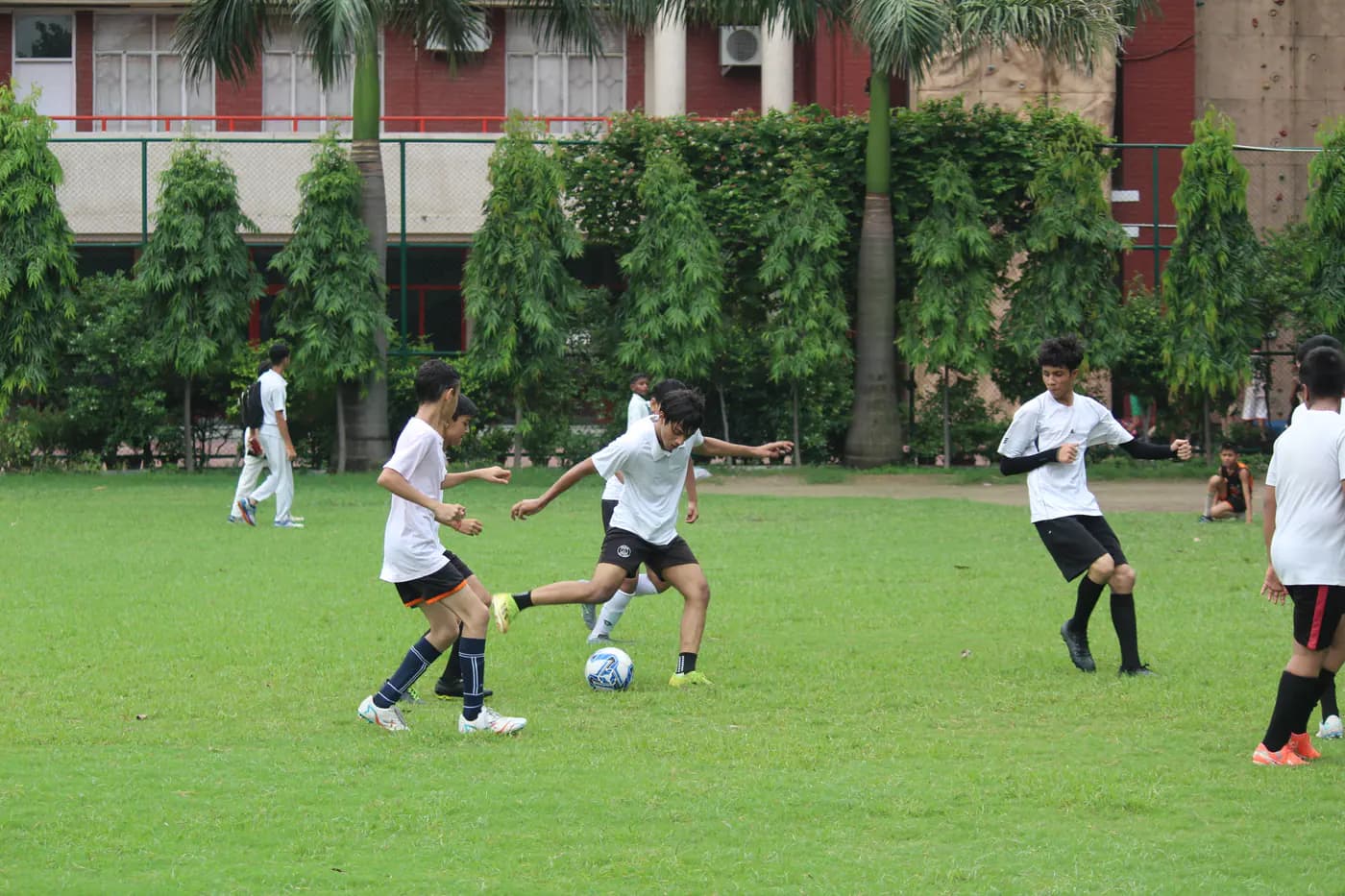 Students playing football on the school field