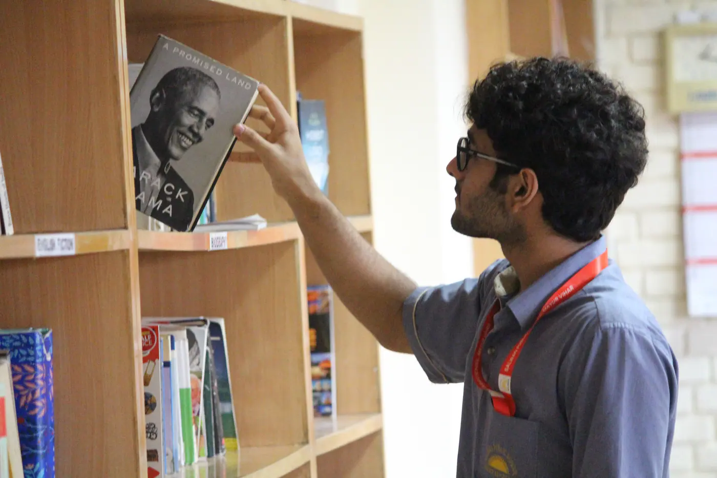 A student choosing a book in the library