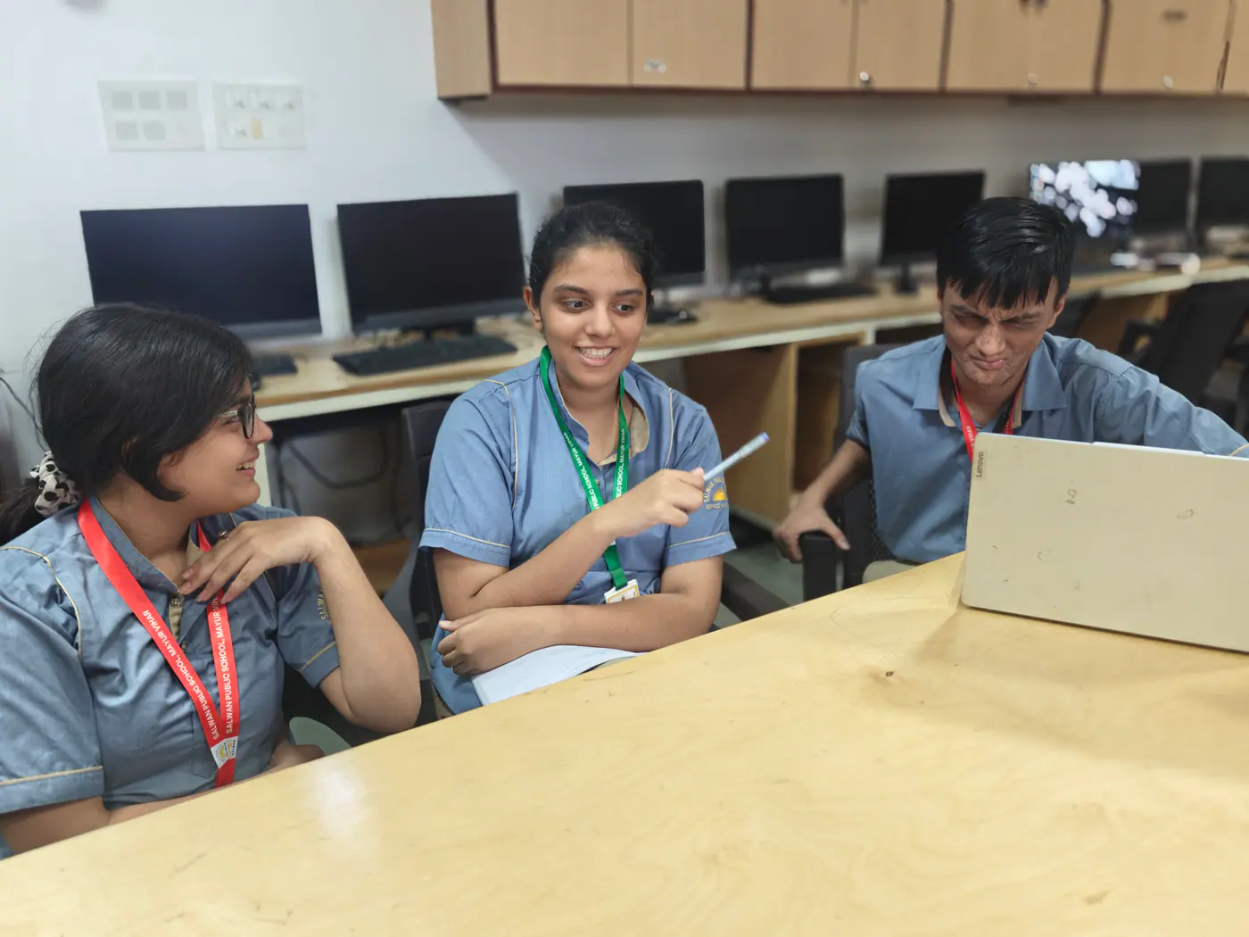 Students collaborating with laptops in the library