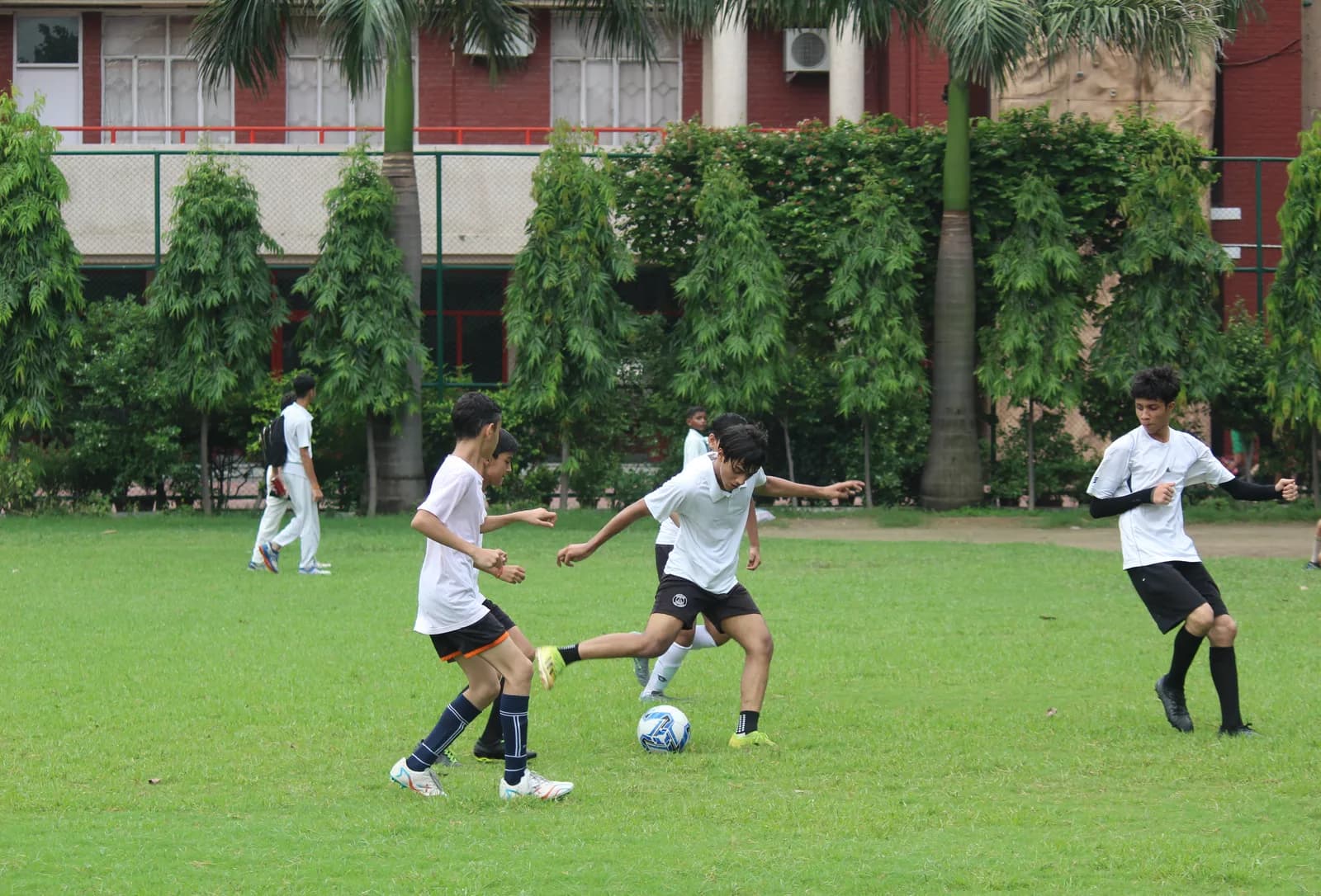 Salwan students playing football on the campus field