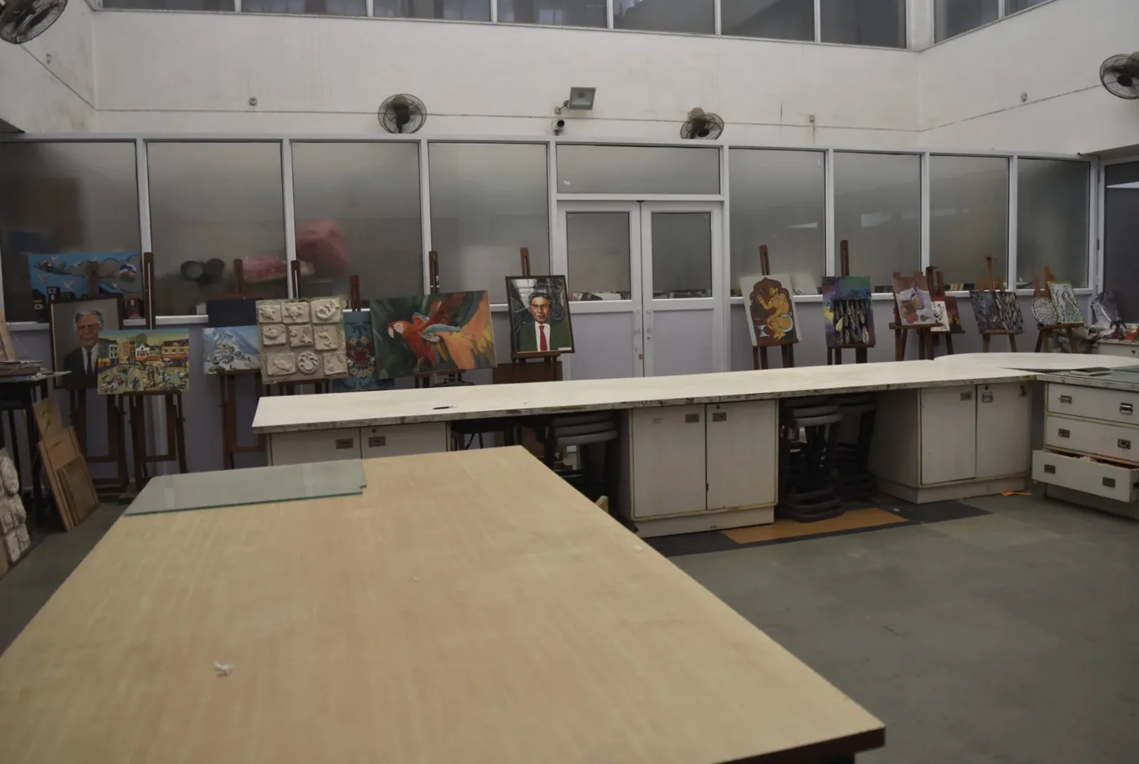 Art room with work tables and student artwork on display