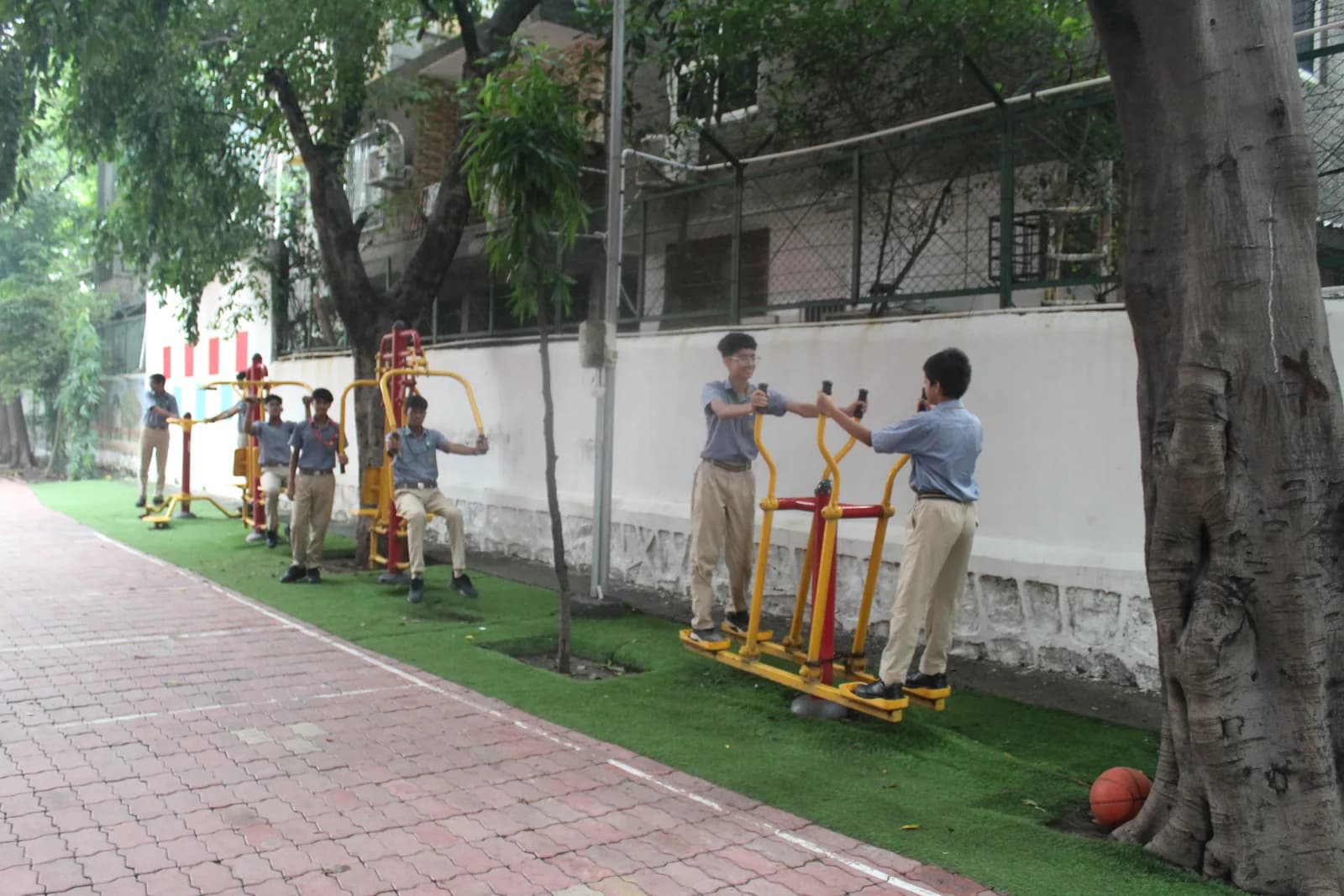 Outdoor gymnasium with fitness stations beside the field