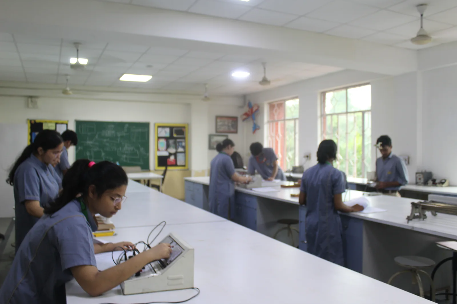 Physics laboratory with measuring apparatus laid out on work benches