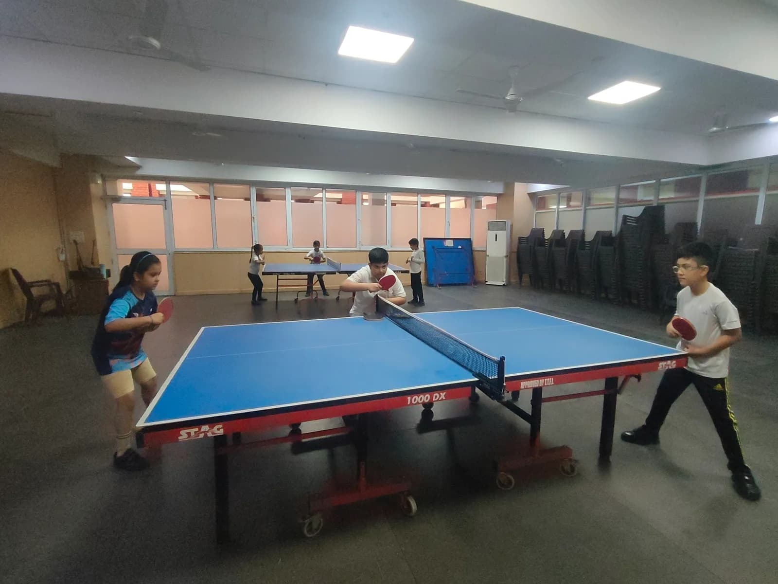Indoor table-tennis tables set up for practice